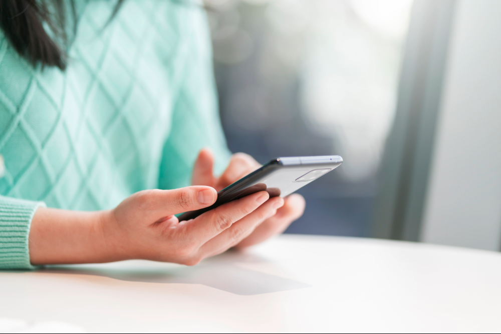 Woman holding cell phone to convert chat into sales